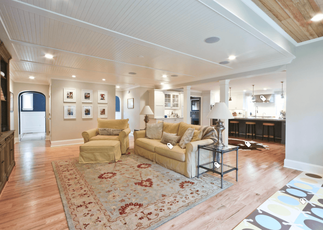 Floral 10x12 rug beneath a large seating arrangement in a bright open-plan living room