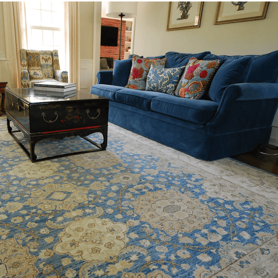 Blue 10x14 rug beneath a sofa and coffee table in a traditional living room