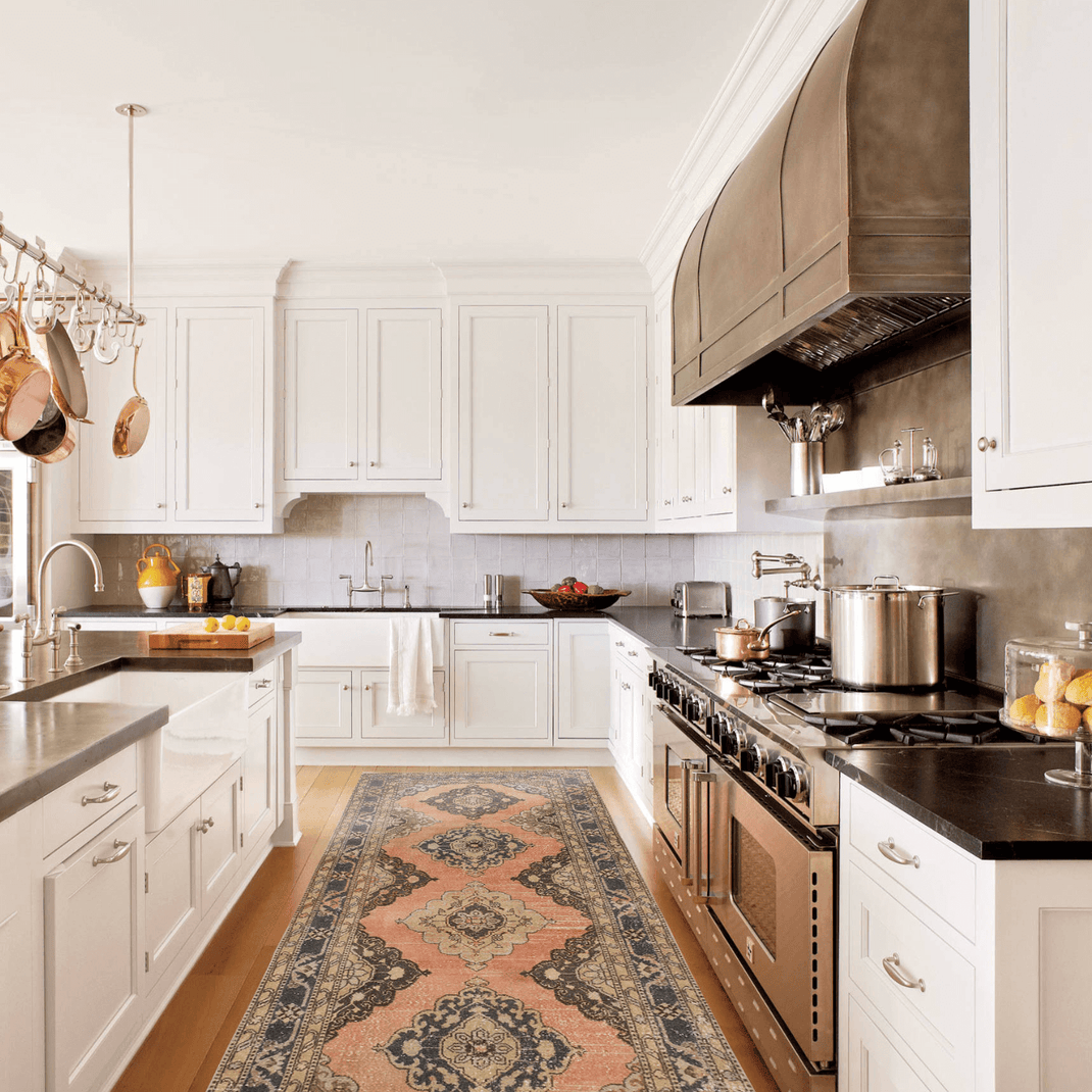 Geometric 13-foot runner rug placed along the cabinets of a bright white kitchen