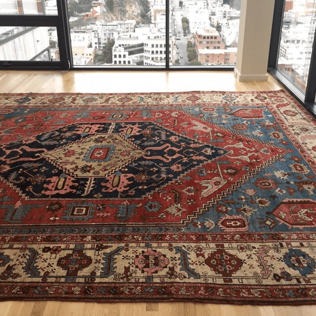 Traditional 5x9 rug in a modern city apartment living room with large windows