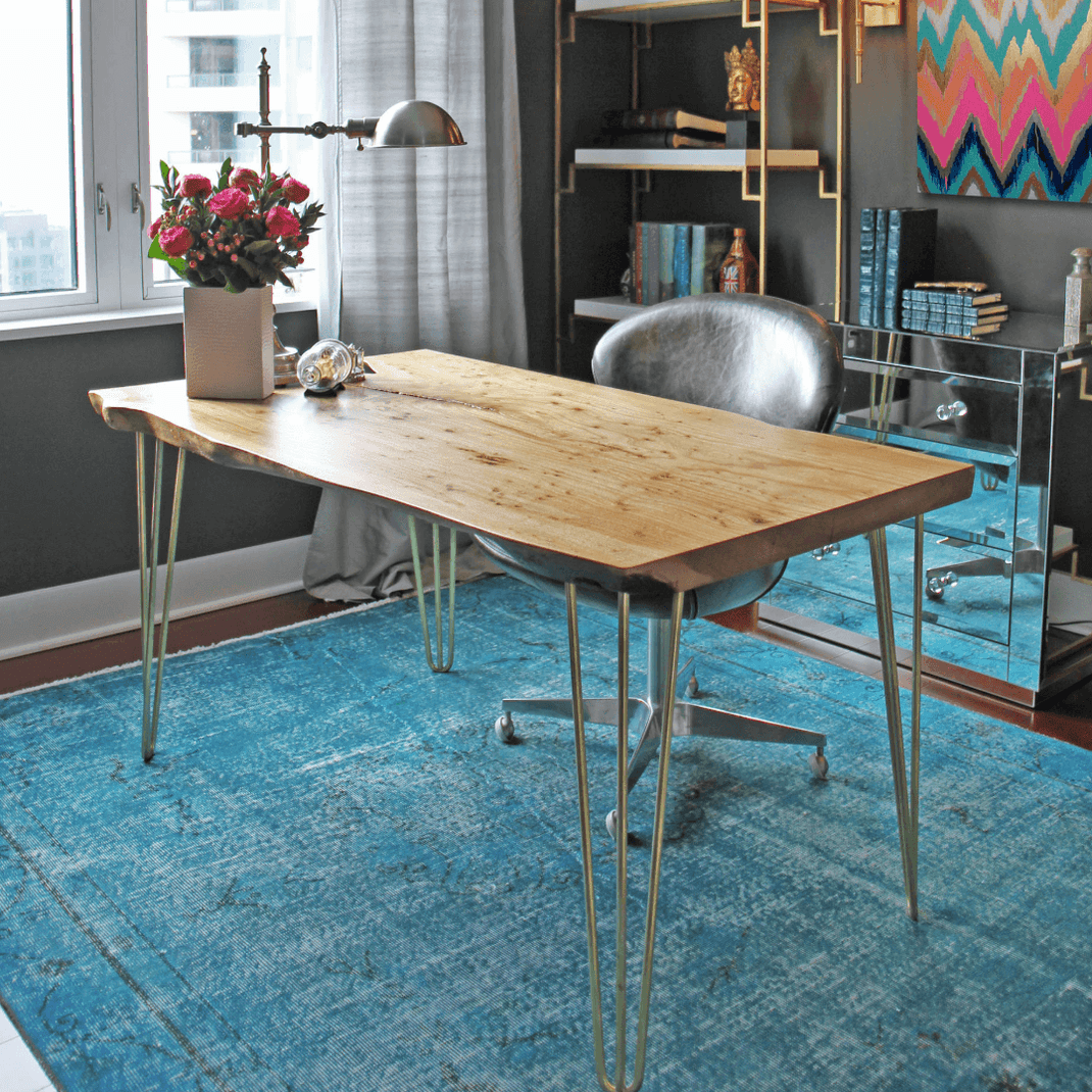Blue 6x10 rug beneath a wooden dining table in a modern open-plan dining room