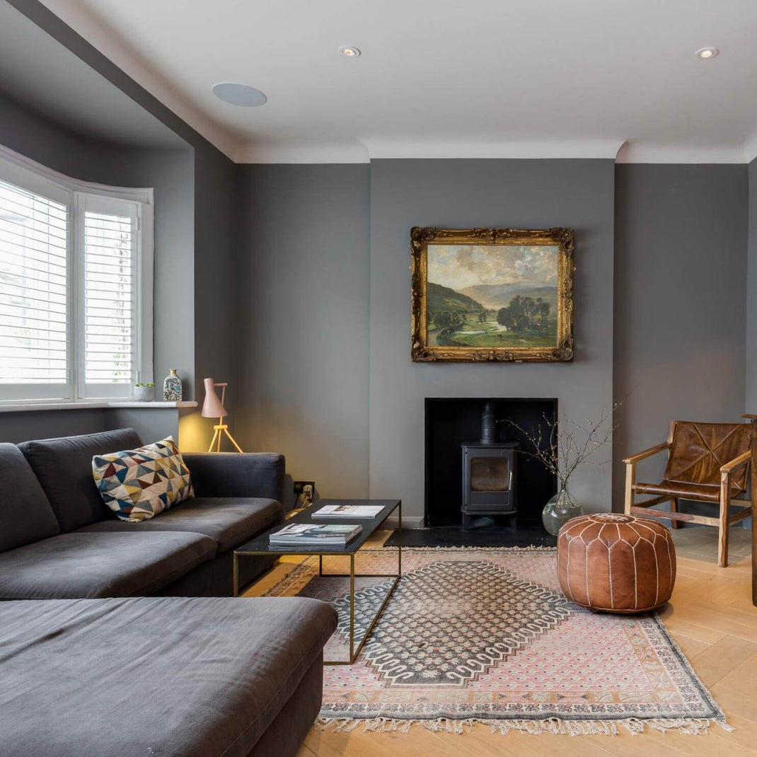 Neutral 6x9 rug defining the seating area of a modern living room with a fireplace