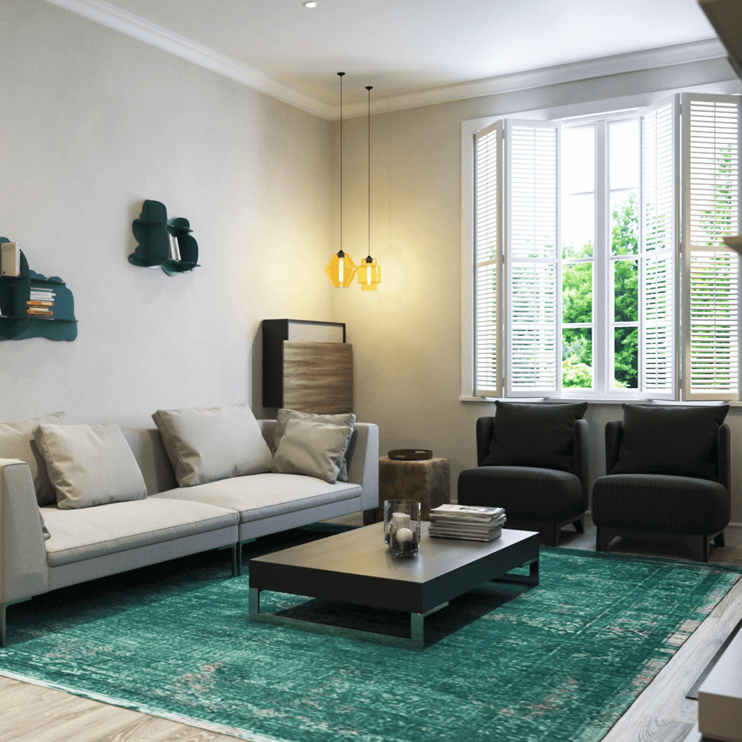 Green 7x11 rug beneath a coffee table in a contemporary living room with neutral seating