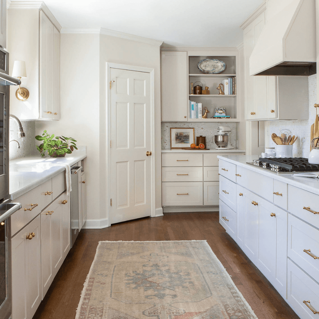 Neutral 8-foot runner rug placed between cabinets in a bright white kitchen
