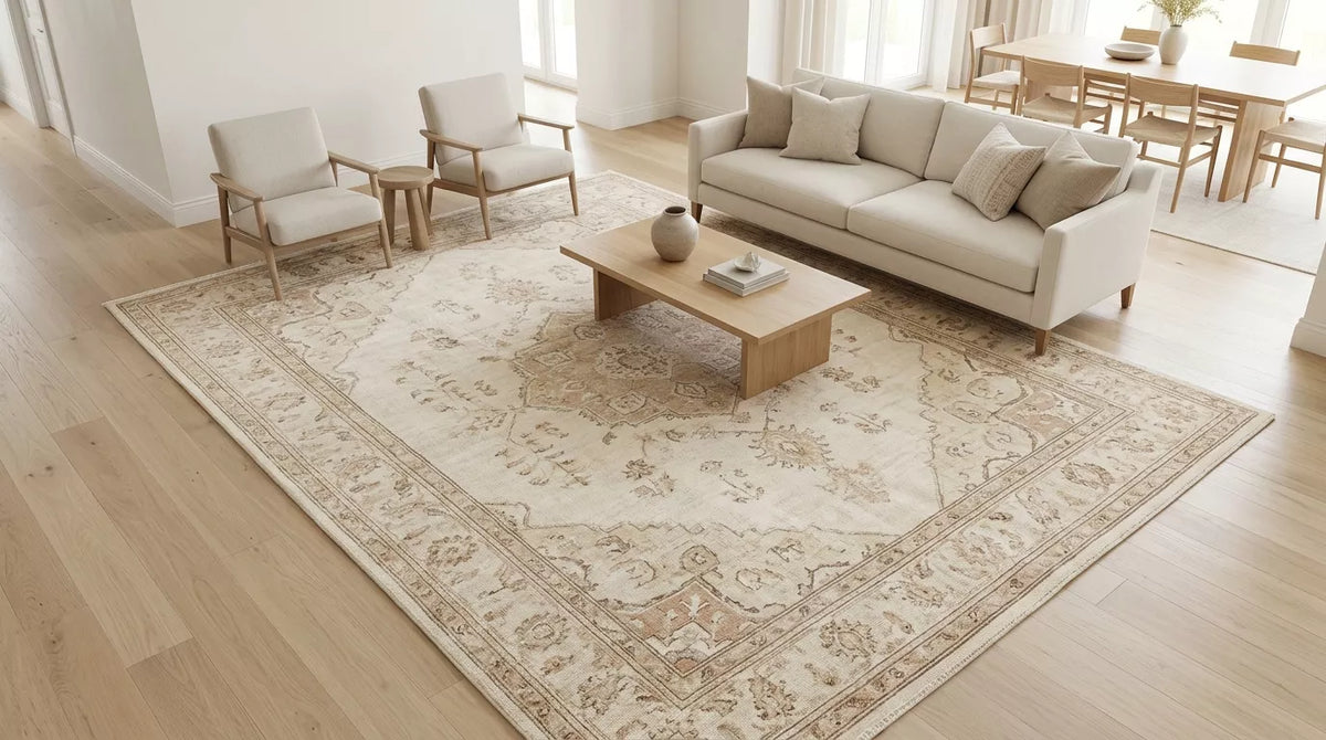 Large handmade 9x12 rug anchoring a bright open-plan living room seating area.