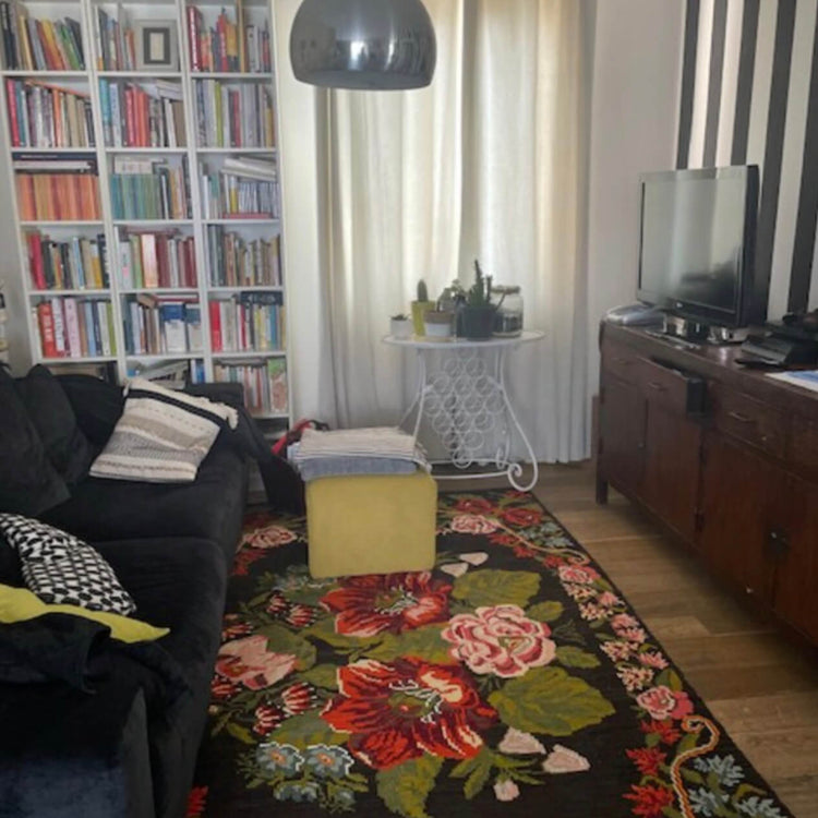 Moldovan rose kilim rug with large floral motifs in a comfortable living room and reading area