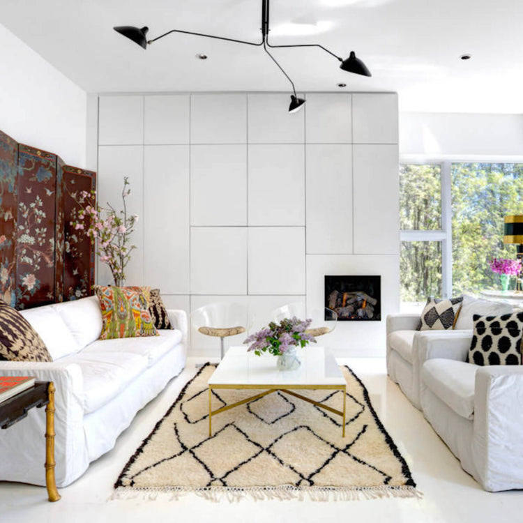 Cream Moroccan rug with black diamond patterns in a bright modern white living room