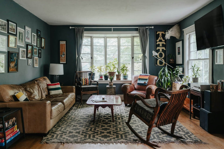Recycled kilim rug in an eclectic living room with vintage chairs, plants and patterned decor